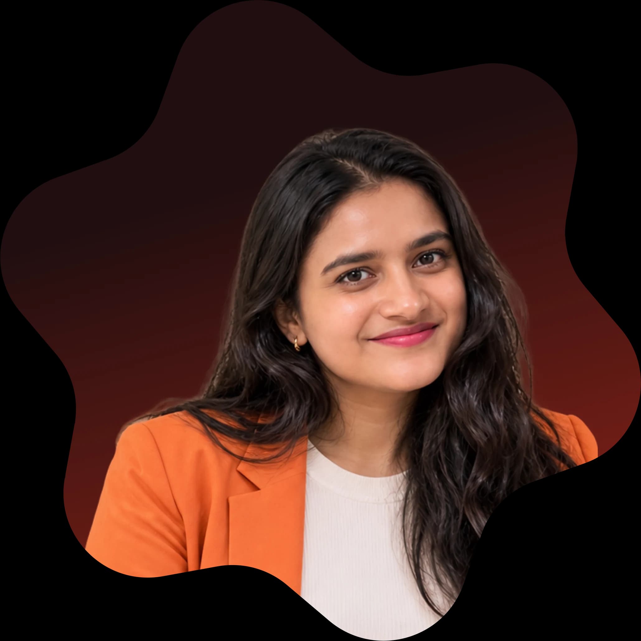 Vibha, founder of Pecan, in an orange blazer